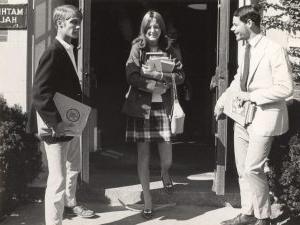 Female 博彩平台网址大全 student with books leaving Mather Hall at registration time, 1969.